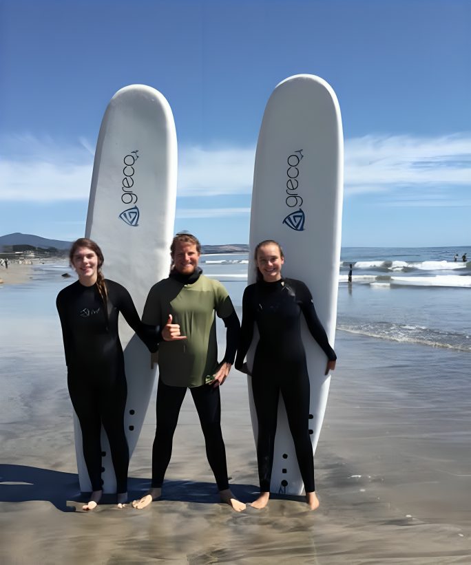 Photo of Janeene Wilkinson, who is current owner of Pillar Point Surf School Along with Students